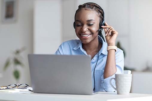 Customer Support. Black woman manager wearing headset and using Customer Support. Black woman manager wearing headset and using